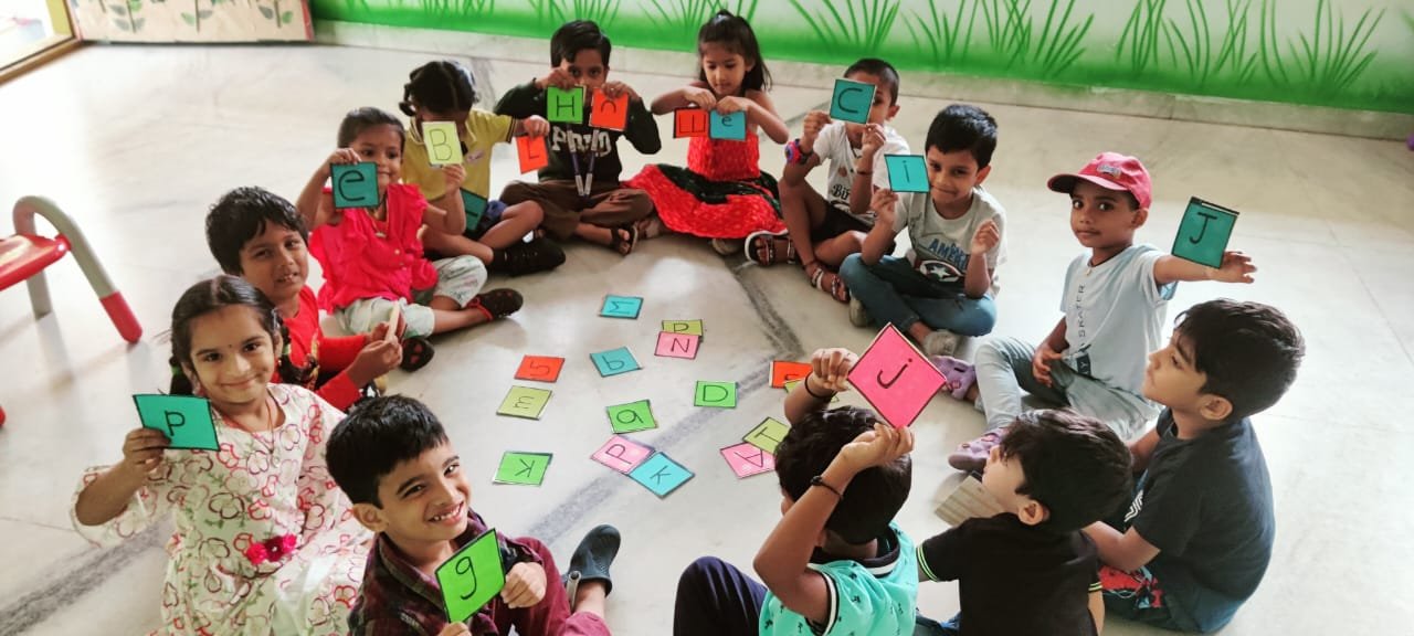 Children learning letters together through a classroom activity